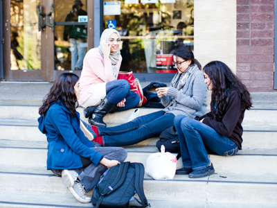 female students sitting on steps of mlk student union